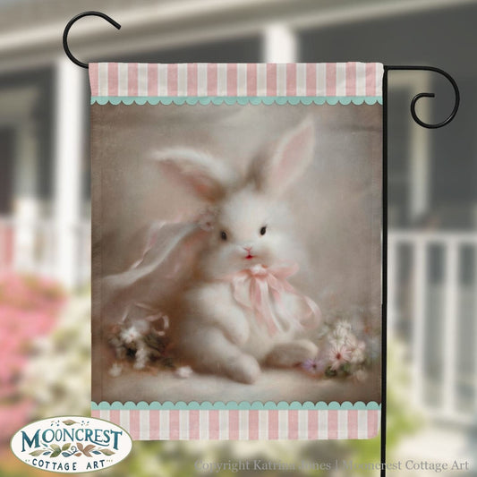 a picture of a white rabbit with a pink bow